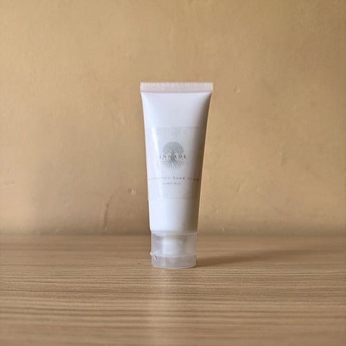 White tube of skincare product on a wooden surface with a beige background