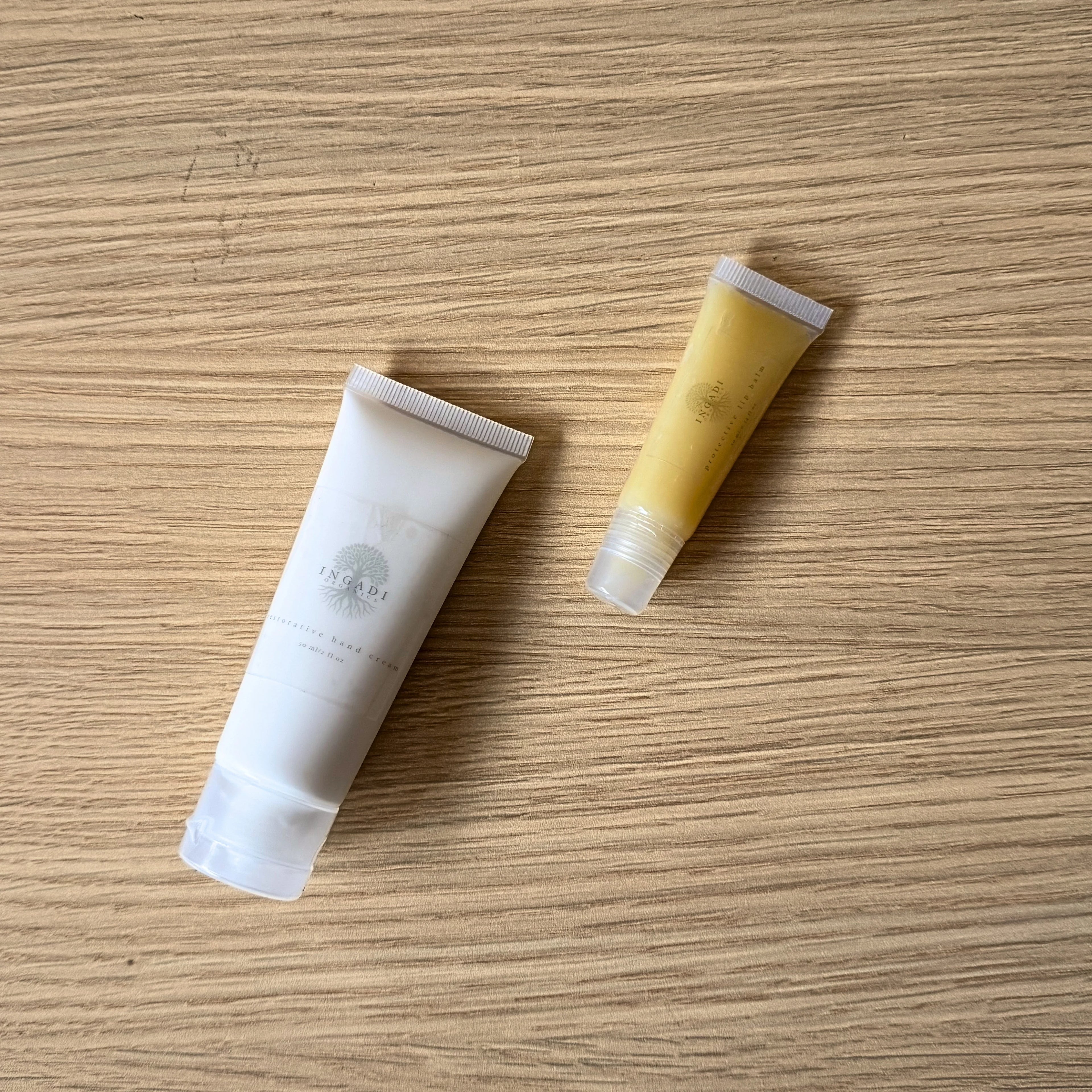 Two skincare products on a wooden surface